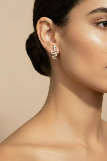 Modelo usando aretes serpiente con microzirconias y ojos verdes